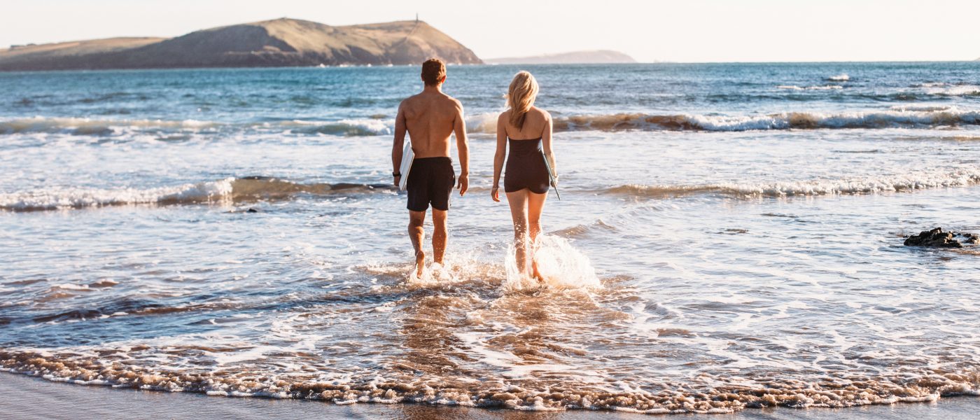 Couple swimming at Polzeath Beach